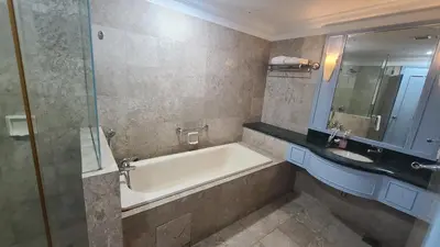 a bathroom with a bath tub and a sink at KL BRB sarvice suite at time square in Kuala Lumpur