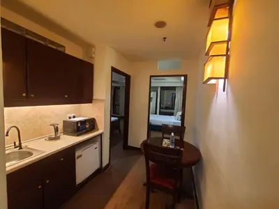 a kitchen with a sink and a table with a microwave at KL BRB sarvice suite at time square in Kuala Lumpur
