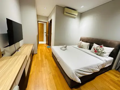 a bedroom with a bed and a flat screen tv at Sky Suites KLCC by NADIA in Kuala Lumpur