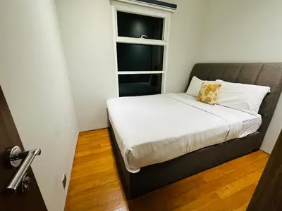 a bed in a small room with a window at Sky Suites KLCC by NADIA in Kuala Lumpur