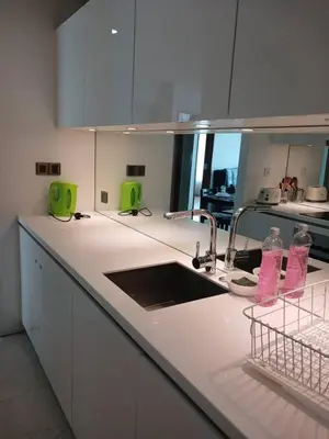 a kitchen with a sink and two water bottles on the counter at VORTEX SUITS KLCC by MMHB in Kuala Lumpur
