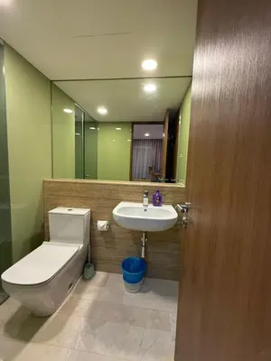 a bathroom with a toilet and a sink and a mirror at VORTEX SUITS KLCC by MMHB in Kuala Lumpur