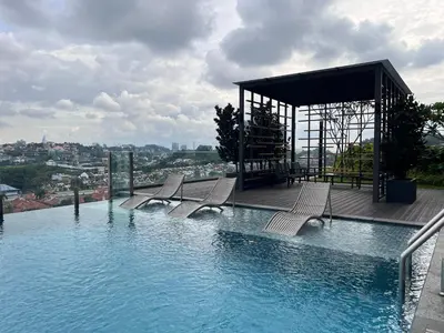 a swimming pool with chairs and a gazebo at Societe Hartamas Kuala Lumpur in Kuala Lumpur