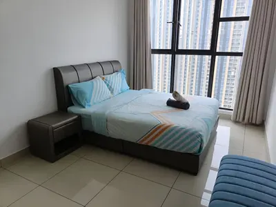 a bed in a room with a large window at Trion Kuala Lumpur by DSM in Kuala Lumpur