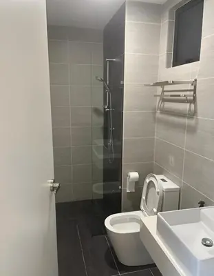 a bathroom with a toilet and a sink at Trion Kuala Lumpur by DSM in Kuala Lumpur