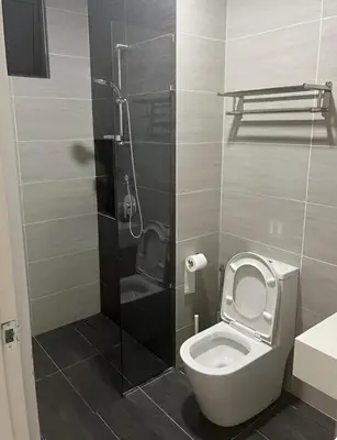 a bathroom with a toilet and a shower at Trion Kuala Lumpur by DSM in Kuala Lumpur