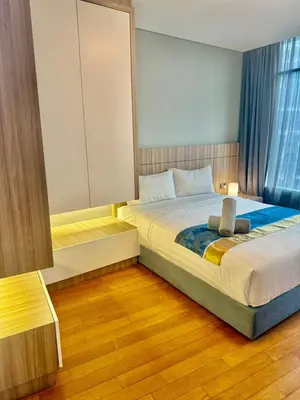 a bedroom with a large bed and a window at Vortex Suites Klcc Area in Kuala Lumpur