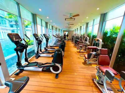 a gym with a row of treadmills and exercise bikes at Vortex Suites Klcc Area in Kuala Lumpur