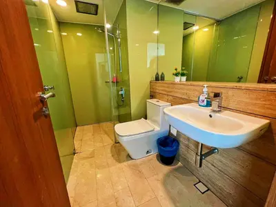 a bathroom with a white sink and a toilet at Vortex Suites Klcc Area in Kuala Lumpur