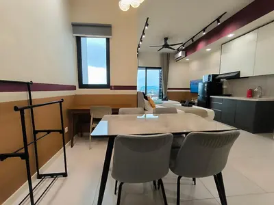 a dining room with tables and chairs and a kitchen at The Pano at Jalan Ipoh Near KLCC By The Homez in Kuala Lumpur