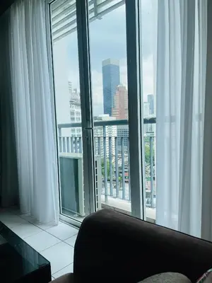 a room with a large window with a view of a city at Seri Bukit Ceylon Suites Bukit Bintang in Kuala Lumpur