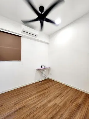 an empty room with a ceiling fan and a table at Cheras MRT KLCC View Home by DefineSuite in Kuala Lumpur