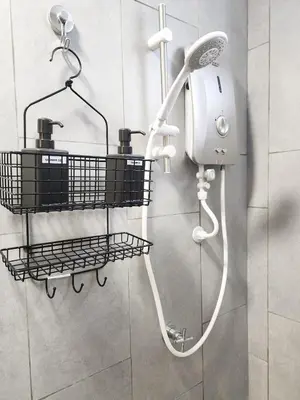 a shower with a hair dryer on a wall at Cheras MRT KLCC View Home by DefineSuite in Kuala Lumpur