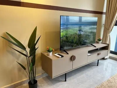 a living room with a large flat screen tv at Agile Bukit Bintang by DeUrban in Kuala Lumpur