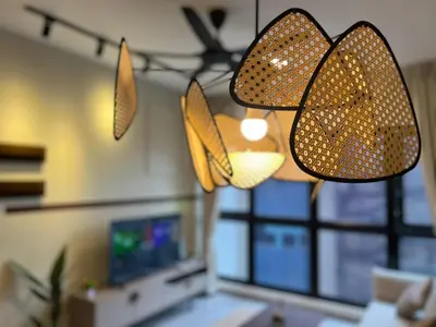 a living room with two lights hanging from the ceiling at Agile Bukit Bintang by DeUrban in Kuala Lumpur