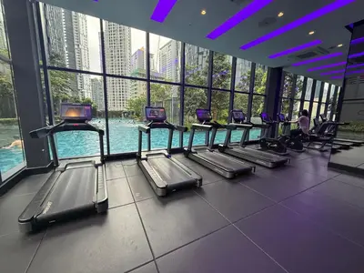 a gym with rows of exercise equipment in a building at Star Residence KL in Kuala Lumpur