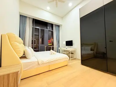 a bedroom with a bed and a chair and a window at Star Residence KL in Kuala Lumpur