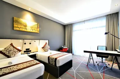 a hotel room with two beds and a piano at M101 Sky Suites at Dang Wangi KLCC in Kuala Lumpur
