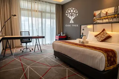 a hotel room with a bed and a desk in a room at M101 Sky Suites at Dang Wangi KLCC in Kuala Lumpur