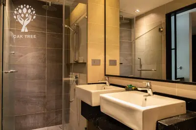 a bathroom with two sinks and a large mirror at M101 Sky Suites at Dang Wangi KLCC in Kuala Lumpur