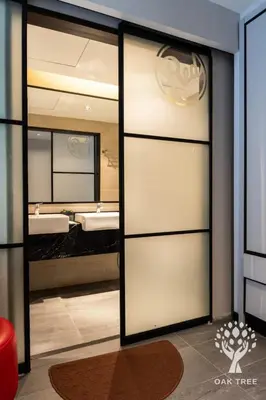 a bathroom with a sliding glass door with two sinks at M101 Sky Suites at Dang Wangi KLCC in Kuala Lumpur