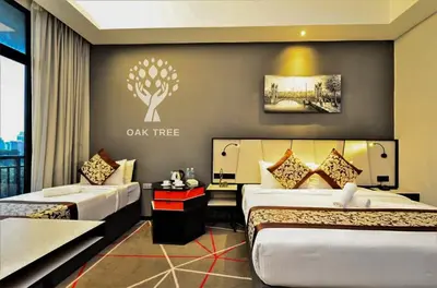 a hotel room with two beds and a couch at M101 Sky Suites at Dang Wangi KLCC in Kuala Lumpur