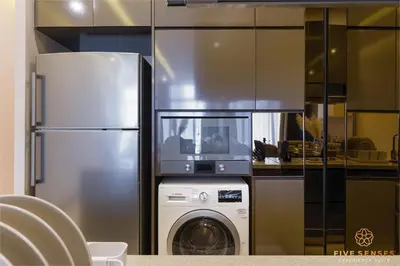 a kitchen with a refrigerator and a washing machine at Dorsett Kuala Lumpur, Five Senses in Kuala Lumpur