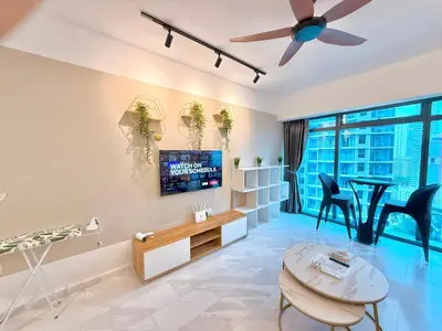 a living room with a tv and a table and chairs at T Hotel Eaton by Klcc in Kuala Lumpur