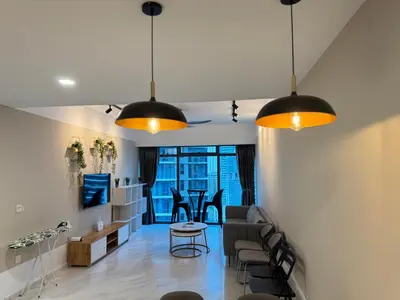 a living room with two hanging lights and a table at T Hotel Eaton by Klcc in Kuala Lumpur
