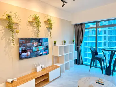 a living room with a tv and a table at T Hotel Eaton by Klcc in Kuala Lumpur