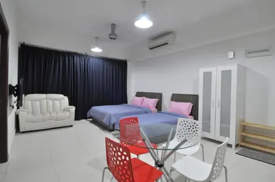 a bedroom with a bed and a table and chairs at BEST KL City View at Regalia Residence in Kuala Lumpur