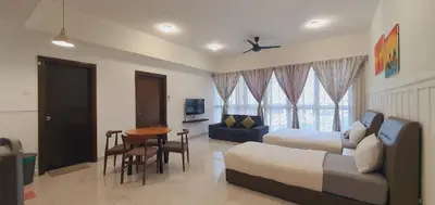 a living room with a couch and a table at BEST KL City View at Regalia Residence in Kuala Lumpur