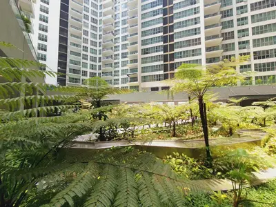 a park in a city with tall buildings at BEST KL City View at Regalia Residence in Kuala Lumpur