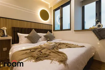 a bedroom with a bed with a blanket and windows at The Riv, Riveria City KL Sentral in Kuala Lumpur