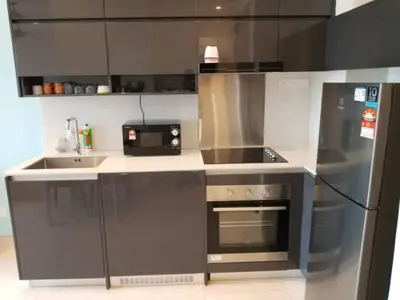 a kitchen with a stove and a microwave at TS Hotel Service Residence Kuala Lumpur in Kuala Lumpur