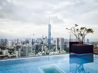a infinity pool with a view of the city at Riveria City by Nomadnest in Kuala Lumpur