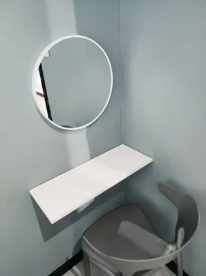 a mirror on a wall next to a chair at Neu Suites Cozy Family House KLCC in Kuala Lumpur