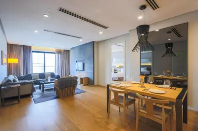a dining room and living room with a table and chairs at 188 Suites Kuala Lumpur in Kuala Lumpur
