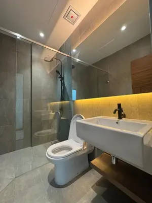 a bathroom with a toilet and a sink and a shower at Alfa Bangsar By Nova Host in Kuala Lumpur