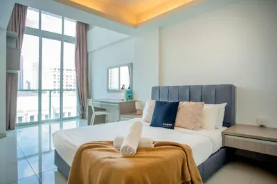 a bedroom with a large bed with a large window at Carlton, Chelsea at Plaza Damas 3, Sri Hartamas Kuala Lumpur in Kuala Lumpur