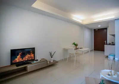 a living room with a tv and a fireplace at Carlton, Chelsea at Plaza Damas 3, Sri Hartamas Kuala Lumpur in Kuala Lumpur