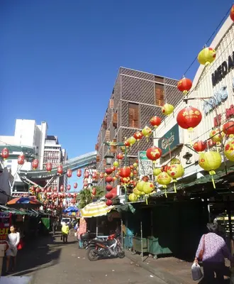 a street with chinese lanterns hanging over a market at Lantern Hotel in Kuala Lumpur