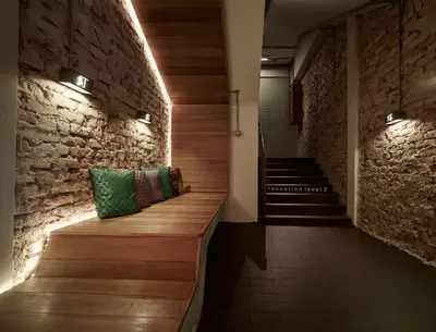 two pillows sitting on a wooden bench in a hallway at Lantern Hotel in Kuala Lumpur