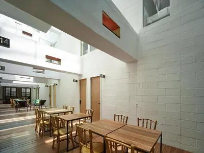 a dining room with wooden tables and chairs at Lantern Hotel in Kuala Lumpur