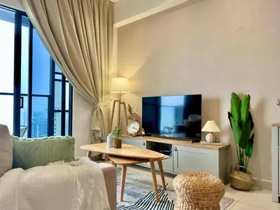 a living room with a tv and a table at New Luxury 2bed 2bath apartment in Kuala Lumpur