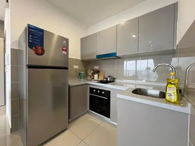 a kitchen with a stainless steel refrigerator and a sink at New Luxury 2bed 2bath apartment in Kuala Lumpur