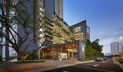 a large building on a city street with a tree at M Centura Sentul Kuala Lumpur, Fully Air-Con 2-Bedroom Home in Kuala Lumpur