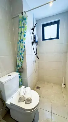 a bathroom with a toilet and a shower and a window at M Centura Sentul Kuala Lumpur, Fully Air-Con 2-Bedroom Home in Kuala Lumpur