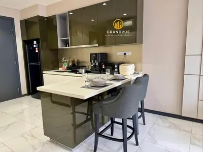 a kitchen with a island with two bar stools at 8 Kia Peng Suites KLCC By HeyStay Management in Kuala Lumpur