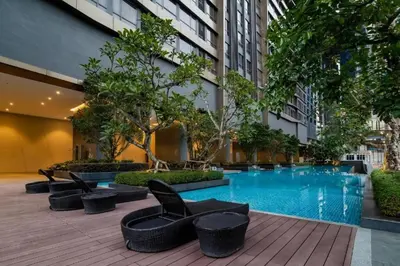 a hotel courtyard with chairs and a swimming pool at 8 Kia Peng Suites KLCC By HeyStay Management in Kuala Lumpur